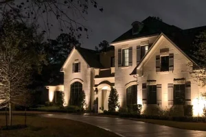 Elegant two-story home illuminated with warm architectural outdoor lighting installation in Kentucky, enhancing curb appeal and nighttime safety.