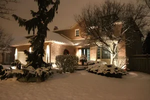 Weather-resistant outdoor lighting illuminating a snow-covered home in Northern Kentucky winter