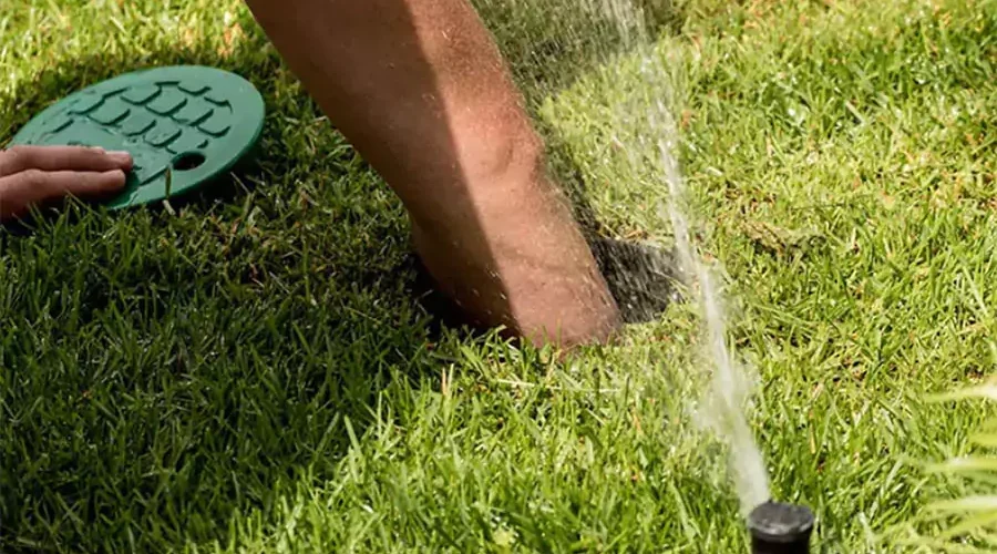 Professional irrigation system maintenance in progress, highlighting the importance of annual checkups to prevent frequent failures and ensure efficient watering.