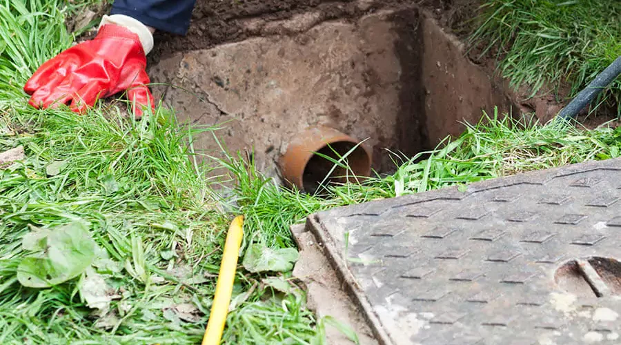 In a green lawn installed drainage and providing drainage services