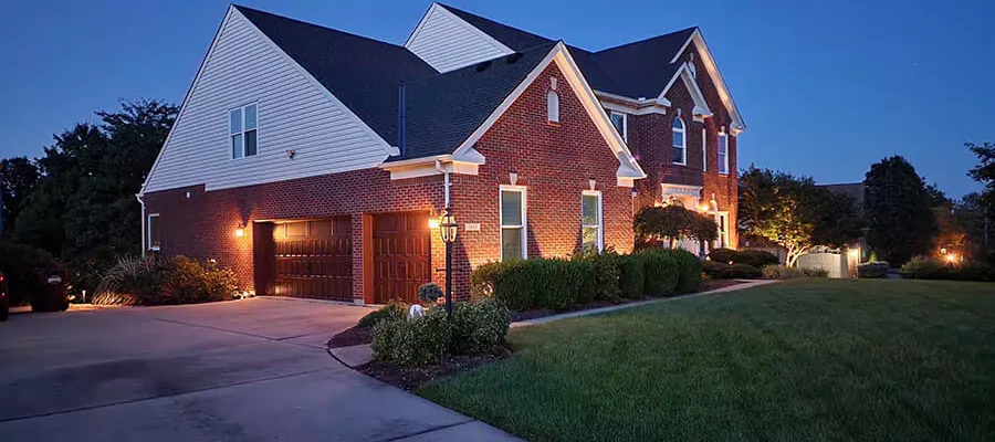 In Front of a house in Amelia, outdoor landscape lighting installed by Expert Irrigation
