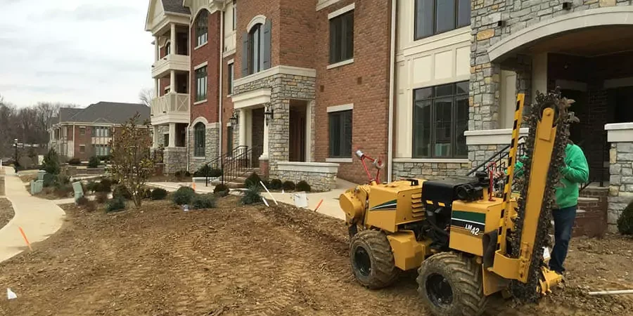 It is a beautiful house in Alexandria, KY and one staff working on the lawn