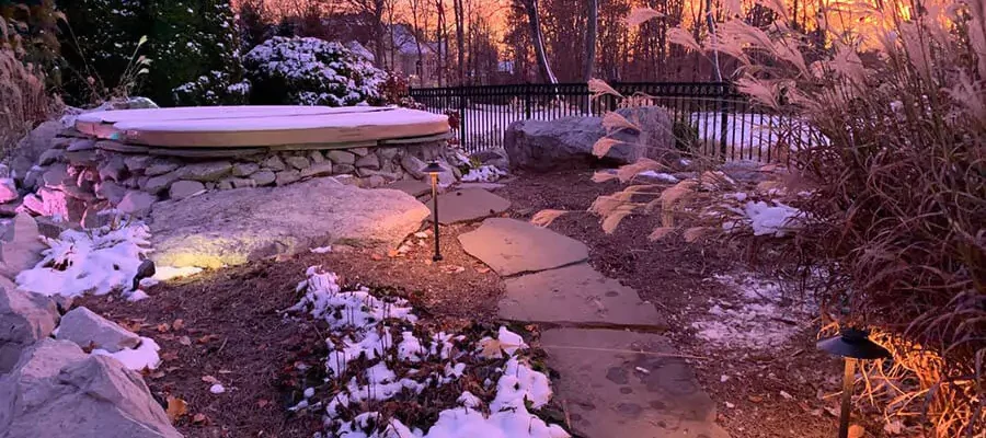 Pathway lighting with a colorful sky & big trees